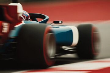 A colorful racing car navigates a track at high speed, showcasing dynamic motion and excitement during a motorsport event. The energy of the competition is palpable.
