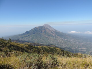 beautiful view of Merbabu mountain with clear and slightly cloudy sky