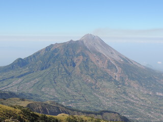 beautiful view of Merbabu mountain with clear and slightly cloudy sky