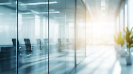 Bright and airy office corridor flooded with natural light from a glass wall, creating a modern and spacious workspace. Blurry background emphasizing open, light-filled environment.