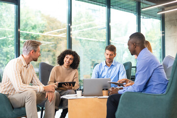Business meeting - manager discussing work with his colleagues.