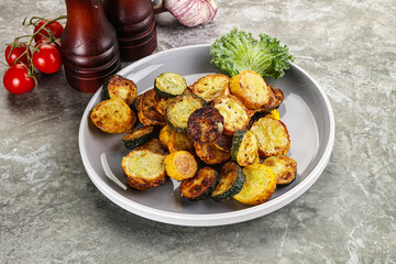 Roasted young zucchini in the plate