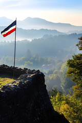 Peaceful Mountainside with National Flag Overlooking Sunrise and Misty Valleys : Generative AI