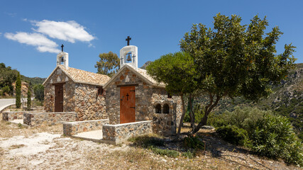 Two small colorful churches besides a mountain road at Kandanos-Selinos, Crete, Greece