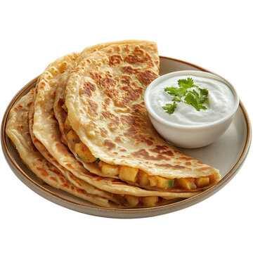 A plate of crispy, golden aloo paratha (stuffed potato flatbread) served with fresh yogurt, pickles, onions, and green chilies. A classic North Indian breakfast dish.