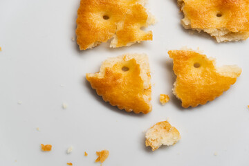 Cracked round crackers on white background