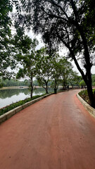 Ragunan, Jakarta - September 24, 2024 Empty sports track or running track or walking track with green trees in the playground