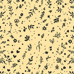 The pattern consists of various black and white floral and leaf designs scattered across a yellow background.