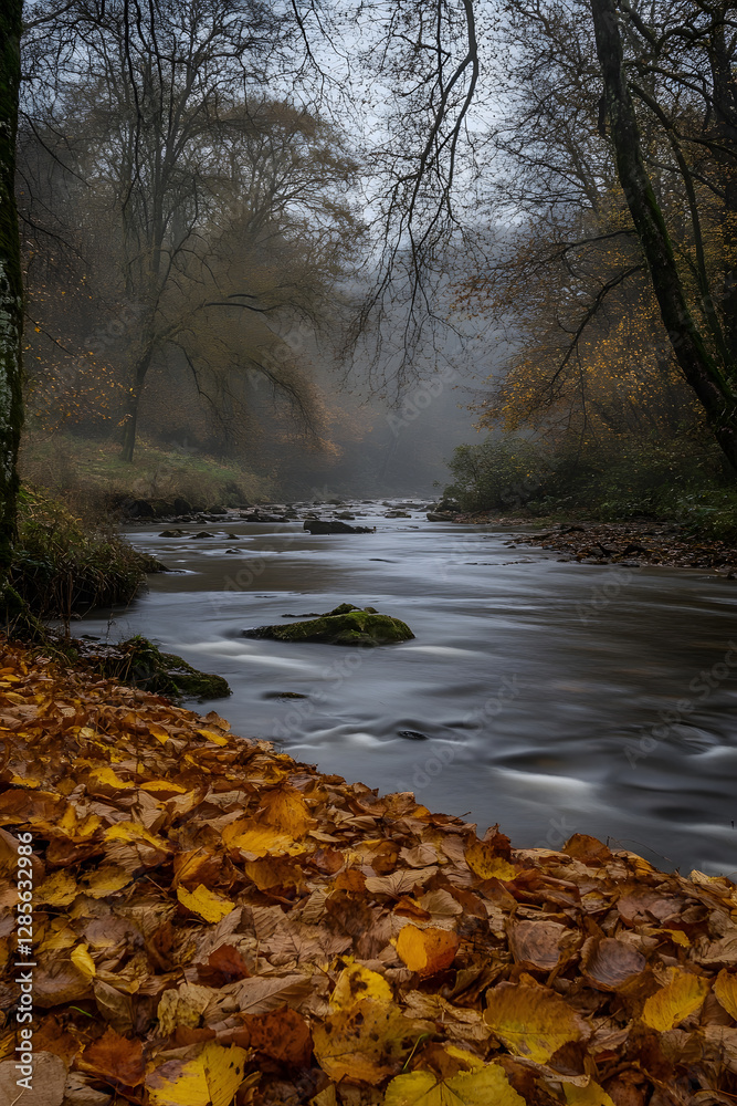 Aufkleber tranquil autumn river scene with lush foliage and gentle stream flowing through a foggy forest : gen