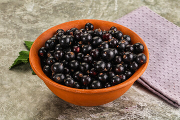 Ripe black currant in the bowl