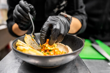 A chef, wearing black gloves, meticulously prepares a gourmet dish, adding fresh diced salsa to a plate. The presentation is artistic, showcasing culinary artistry and creativity.