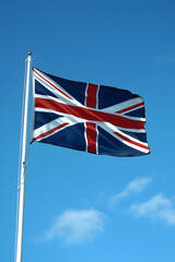 United Kingdom Union Jack Flag Waving Against Clear Blue Sky on a Sunny Day : Generative AI