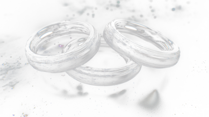 two silver rings on a black surface