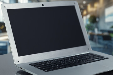 Fototapeta premium Modern Laptop with Blank Screen in a Bright Office Environment