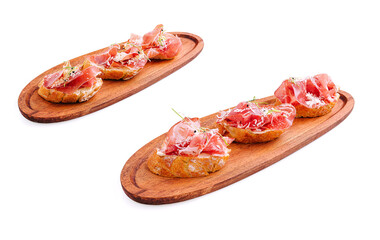 Delicious tapas featuring cured ham on wooden serving boards