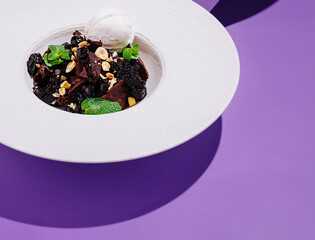 Delicious dessert served in a modern bowl with ice cream and toppings