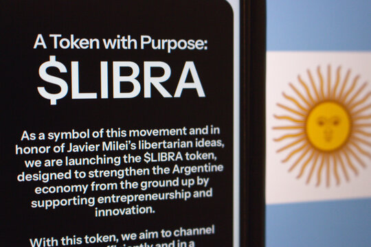 Mexico City, MEXICO - Feb 23 2025 : A smartphone screen displaying information about the $LIBRA token, linked to libertarian ideas and Argentina&rsquo;s economy, with the Argentine flag in the background.