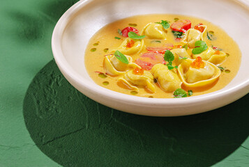 Delicious tortellini in creamy sauce garnished with herbs