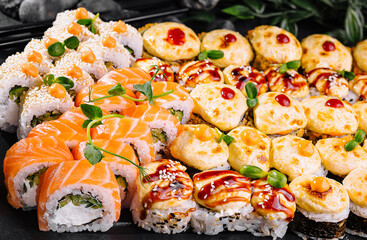 Assorted sushi platter on dark stone background