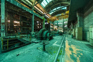 Fototapeten Verlassene Gebäude Huge abandoned coal-fired power station - turbine hall with green machines stretches endlessly towards the vanishing point  © Carismarkus