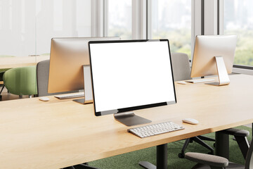 Modern office interior with blank monitor screen on wooden desk. 3D Rendering