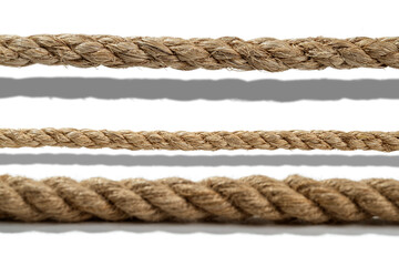Closeup view set of various straight ropes string isolated over white background
