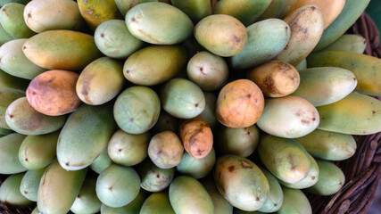 Closeup of fresh, raw, Banana passionfruits (Maracuga banana) on a greengrocers stall at a market in Madeira