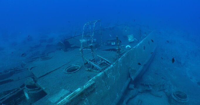 wreck underwater shipwreck on seabed sea floor standing metal on ocean floor some fish around