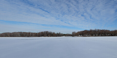Winter fishing on the lake, beautiful panorama.