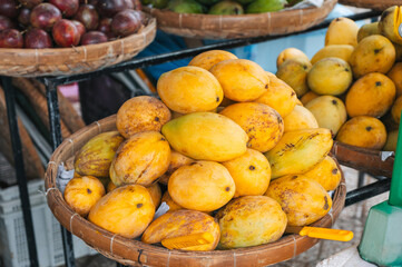 ripe yellow mangoes at the Asian food market in Asia in Vietnam