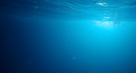 Obraz premium Underwater bubbles rising background. Soft light filtering through the deep blue ocean