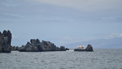 Black rocks in the ocean.