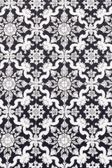 Traditional Italian ceramic tiles showing intricate floral patterns in black and white