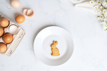 White plate with bunny shaped cookie eggs and white napkin