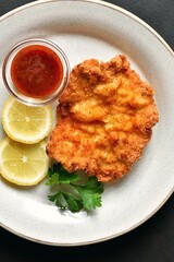 Schnitzel served with sauce, top view