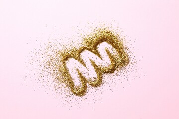 Beautiful shiny gold glitter on color background, top view