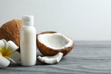 Bottle of coconut oil on wooden background