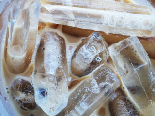 Close-Up View of Refreshing Iced Coffee With Ice Cubes and Cream