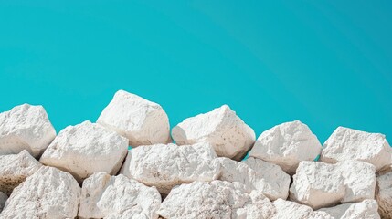 White rocks against vibrant blue sky, minimalist background, design element