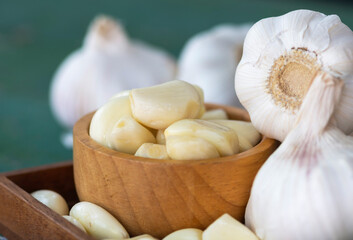 Peeled garlic in wooden bowl