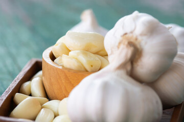 Peeled garlic in wooden bowl