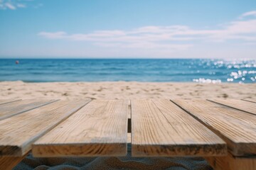 Fototapeta premium A wooden table sitting on top of a sandy beach, perfect for outdoor gatherings or coastal-themed settings