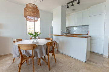 a dining table with wooden chairs next to wooden countertop kitchen 