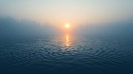 Obraz premium A serene view of the sun above misty water at dawn