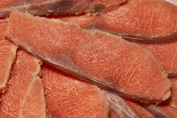 Slicing frozen coho fillet for the festive table. Homemade food. Close-up.