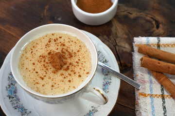 cup of salep with cinnamon powder on the rustic wood background - sağlep