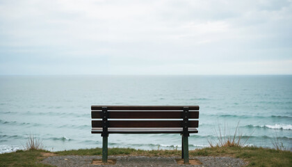 Wooden bench overlooking the ocean on a cloudy day.