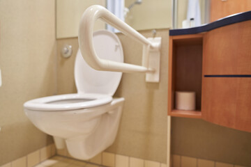 Close-up of the toilet handrails. A public toilet for people with disabilities. Special plastic handrails in the bathroom. With space to copy. High quality photo