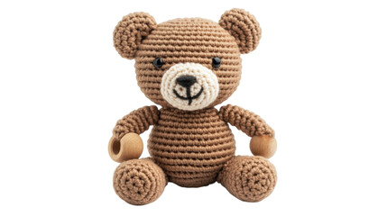 Sweet crochet bear toy sitting with a wooden rattle in its paw and a friendly expression