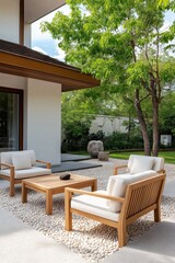 Fototapeta premium A white house with a patio area with a wooden table and chairs. The patio area is surrounded by trees and has a peaceful, relaxing atmosphere